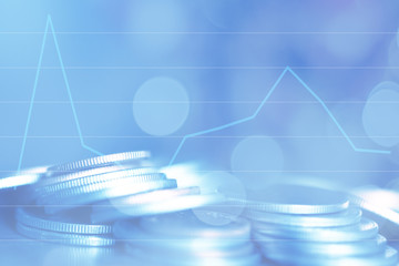 Double exposure Rows of coins of Graph on the table,finance and business concept,Money,soft focus and blurred style,dark tone.