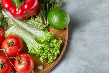 Delicious composition of assorted fresh vegetables and herbs on white textured background, top view, selective focus.
