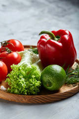 Delicious composition of assorted fresh vegetables and herbs on white textured background, top view, selective focus.