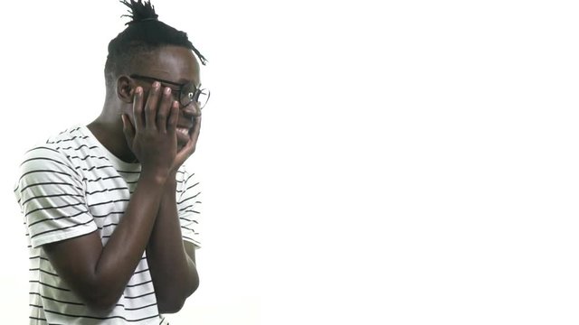 The cute black man in glasses is embarrassed