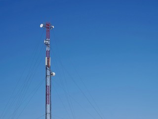 An object. Antenna of radio communication and mobile communication against the blue sky.