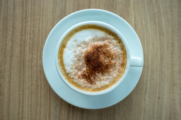 Top view hot cappuccino coffee isolated on table