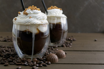 Coffee in double-walled glass on a wooden table.