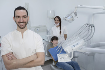 Fototapeta premium A portrait of a dentist with his team working in the background