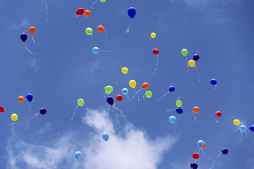 Balloons flying on background of the blue sky