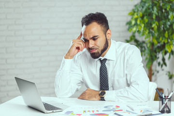 Young business man with problems and stress in the office