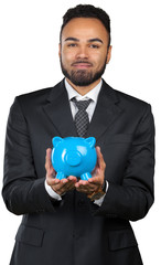 African American business man holding a piggy bank