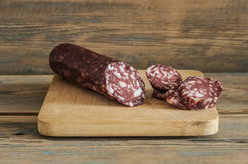 sausage on wooden aged background.