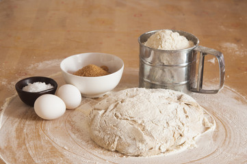 Raw wheat yeast dough on the table sprinkled with flour