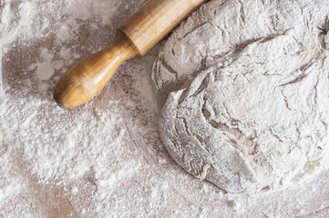 sifted flour on the table, a rolling pin . Free space for text .