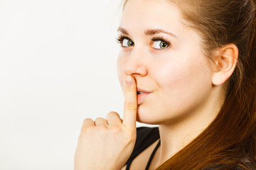 Woman showing silence gesture with finger