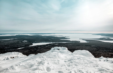 Winter landscape. Magnificent view from Mount Kivakka at the mouth of the Olanga River and Lake Piaozero. North Karelia. Russia
