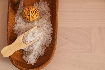 Spa concept. White bath salt on the whit wooden background 