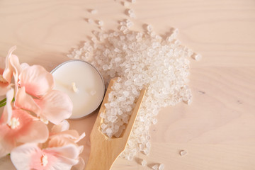 Spa concept. White bath salt on the whit wooden background 