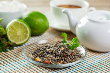 Fototapeta na wymiar cup of black tea with mint leaves on a wooden table