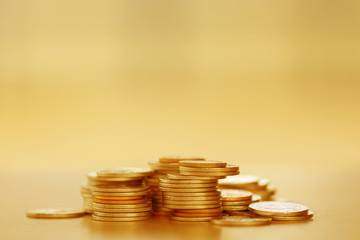 Row of coins on wood background for finance and Saving concept,Investment, Economy, Soft focus and dark style.
