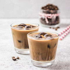 Iced coconut mocha coffee on concrete background. Selective focus, copy space. 