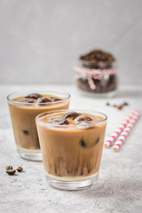 Cinnamon vanilla iced coffee on concrete background. Selective focus, copy space. 