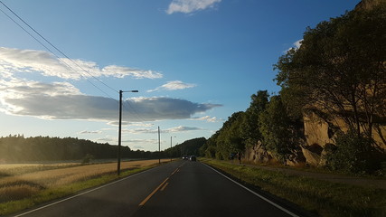 Empty Norwegian road near the rocky hill