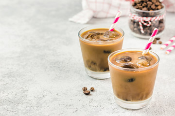 Creamy vanilla mocha iced coffee on concrete background. Selective focus, copy space. 