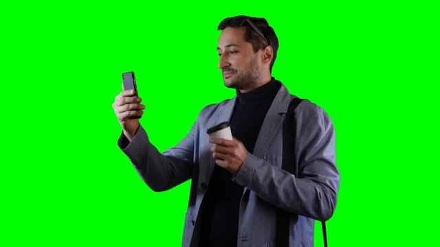 A man is talking on a mobile phone in video mode