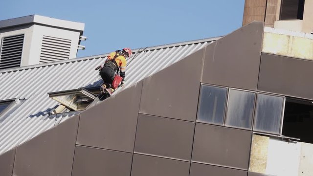 The worker on the roof is insured against falling by special equipment.