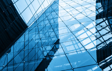 Fototapeta na wymiar Geometric structure glass windows in skyscrapers