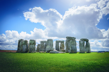 Stonehenge an ancient prehistoric stone monument on blue sky in Wiltshire, UK.