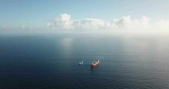 Aerial view of an offshore oil installation and supply ship