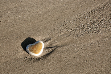 Fototapeta na wymiar Stone heart on the beach.