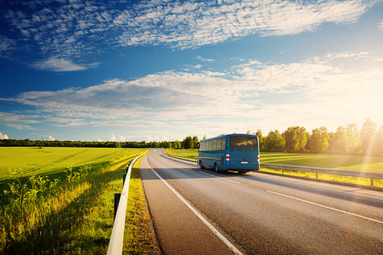 Bus on asphalt road in beautiful spring day at countryside