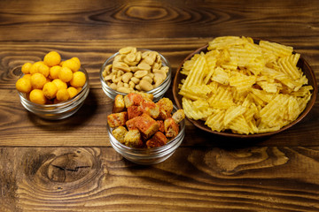 Mix of snacks for beer on wooden table