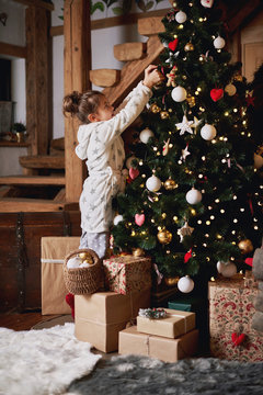 Young girl decorating Christmas tree