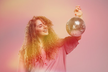 Naklejka premium Party woman with curly hair disco ball. Student meeting, party, holiday