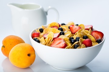 Bowl of Cornflakes, Blueberries, Strawberries and Milk
