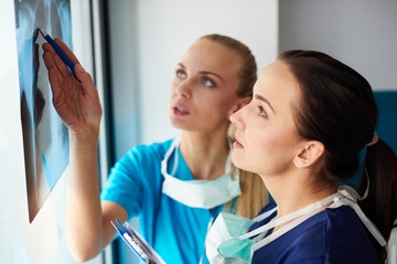 Two surgeons looking at x-ray