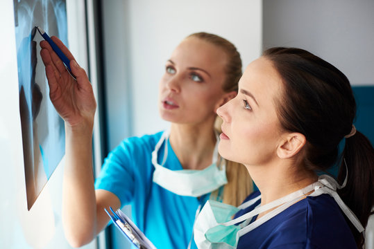 Two surgeons looking at x-ray