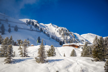 Fototapeta na wymiar Alpine hut in the snow. Winter ski resort in Austria - Hochzillertal