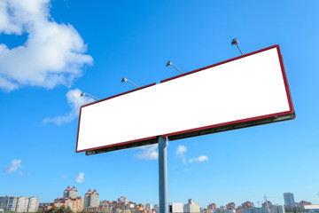 Blank billboard mock up against blue sky and blur cityscape background