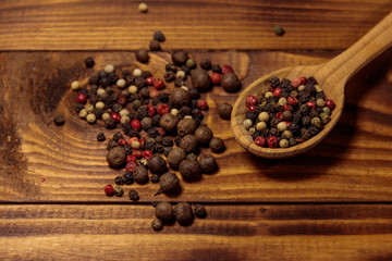 Mix of peppercorn in wooden spoon on a table