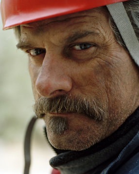 Portrait of a mature man wearing a hardhat.