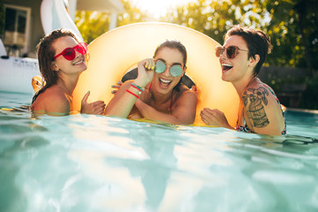 Women friends enjoying together in pool