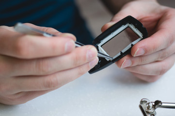 Repair of electronic spare parts..Men's hands with a soldering iron.