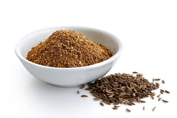 Poster Ground cumin in white ceramic bowl isolated on white. Whole cumin. © Moving Moment