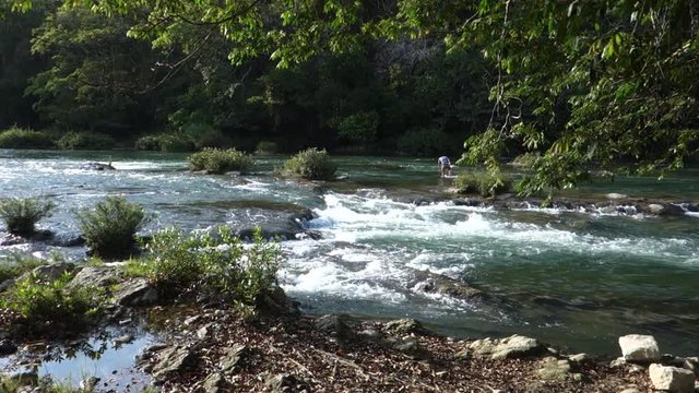 The Macal River flows through Belize.