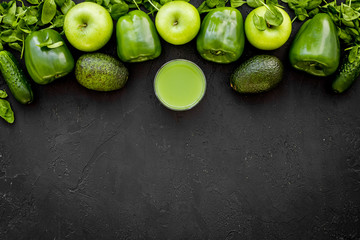 Greeny vegetable smoothie in glass on black background top view mock up