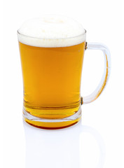 Mug of beer with foam isolated on white background with shadow reflection. Half a liter of beer in glass on white backdrop. Ale in bock. A pint of beer.
