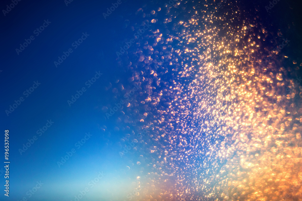 Poster glitter lights abstract background with gold particles. defocused bokeh dark festive texture.