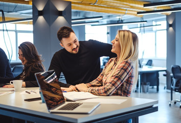 Man flirting with female colleague at the office meeting