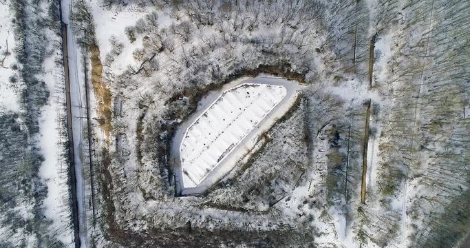 Aerial view of beautiful ancient fortress in forest in winter. Tarakaniv Fort.